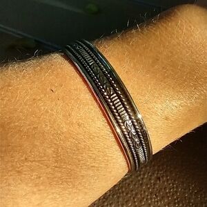 Women's silver tone decorative cuff bracelet.